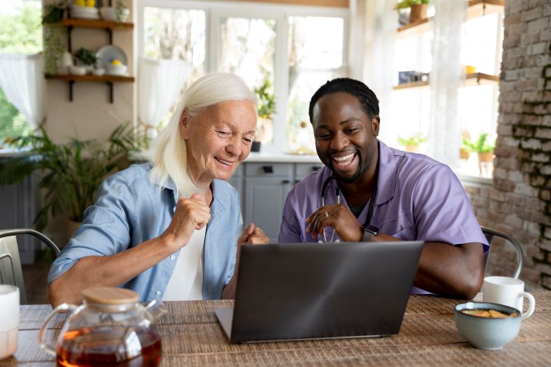 Senior woman smiling with caregiver in garden
