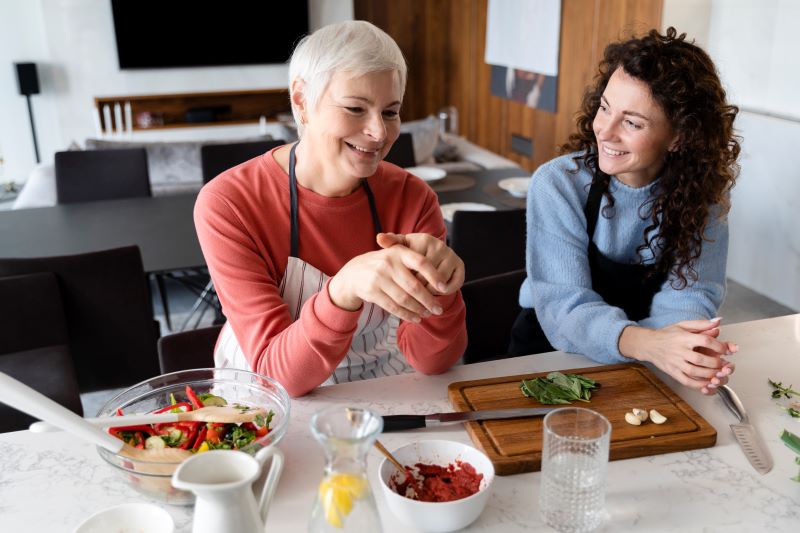 Caregiver preparing meal for senior